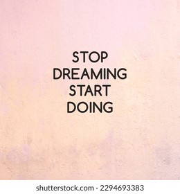 Stop Dreaming Start Doing text on concrete wall