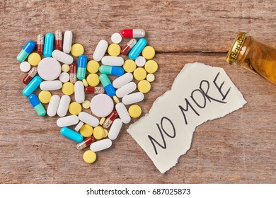 Stop Drinking Guide. Shape Of Heart From Pills, Message No More, Neck Of Bottle, Wooden Background.