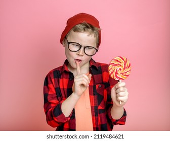 Stop eating sugar. Kid say no for candy lollipop. Child with sweet in hand with stop sign. School boy has diet. Choice. Lollipop