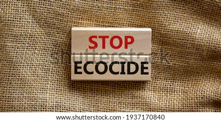 Stop ecocide symbol. Wooden blocks with words stop ecocide. Beautiful canvas background, copy space. Business, ecological and stop ecocide concept.