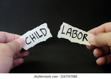 Stop and fight child labor concept. Human hand tearing a piece paper with written word child labor. Children rights protection.