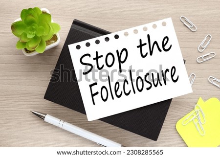 Stop the Foreclosure . text on white page on black notepad