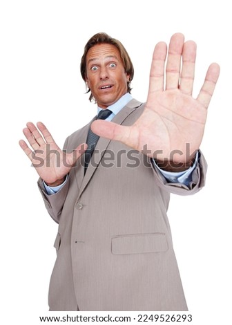 Stop, hand and businessman in shock in a studio with a frightened or scared facial expression. Surprise, fear and portrait of a male in a suit with a hold gesture isolated by a white background.