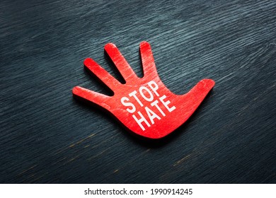 Stop hate phrase on the small hand. - Shutterstock ID 1990914245