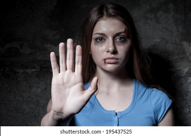 Stop Hurting Woman! Young Beaten Up Woman Looking At Camera And Stretching Out Hand While Standing Against Dark Wall