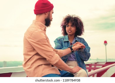 Stop It. Serious Young Girl Sitting With Her Boyfriend And Touching His Hand While Having Difficult Conversation With Him