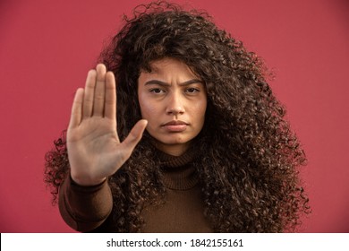 Stop It. Woman's Fist Of Female Power. Woman Victim Of Racism. Abuse At Work. The Feminine Power. Female Empowerment. The Strength Of Women. Red Background.