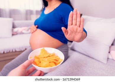 Stop To The Junk Food During Pregnancy. Pregnant Woman Refuses To Eat Unhealthy Chips.  