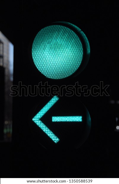 Stop Light, Traffic Light Green Go light with\
green left turn arrow under a bridge, dark background, car\
transportation sign signal