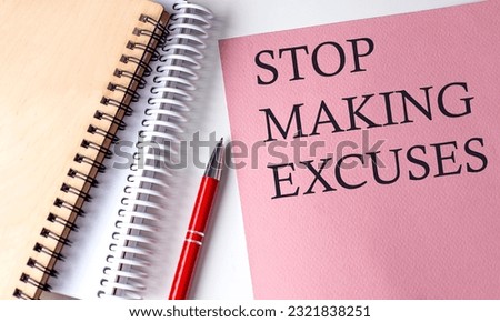 STOP MAKING EXCUSES word on the pink paper with office tools on a white background