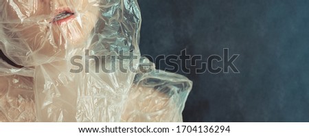 Stop ocean and planet plastic pollution banner. Beautiful young woman, her head turns into a bag and suffocates. Concept Stop Using Plastic Packaging Bag, Plastic will kill you. Claustrophobia, fear.