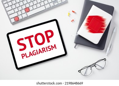 Stop plagiarism concept. Flat lay digital tablet with text STOP PLAGIARISM on screen, keyboard with lighted keys control c, paper notebooks, glasses on white desk. - Shutterstock ID 2198648669