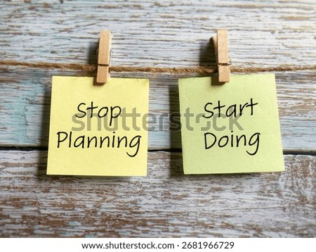 Stop planning start doing text written on notepaper background. Stock photo.