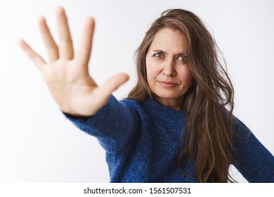 Stop Right There Young Lady. Displeased Strict And Bossy Female Parent In 50s Pulling Palm Towards Camera In Forbid Gesture Looking Displeased And Dissatisifed, Restricting And Forbidding Something