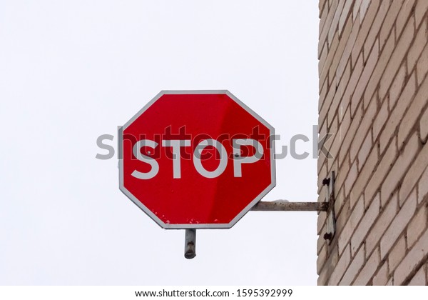 Stop road sign mounted on\
the wall
