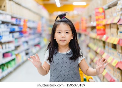 Stop Shopping In Supermarket.Happy Little Asian Girl In Supermarket With Mom.Little Girl Post Stop Shopping  In Hypermarket With Family.