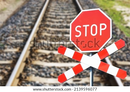 Stop sign background. Long railway landscape. Road sign suggesting caution. Watch out for a train. Rail crossing danger background.