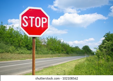 Stop sign by the empty road