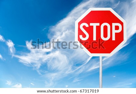 stop sign with a cloudy sky