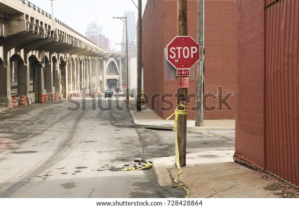 Stop sign in empty street along bridge in Kansas\
City, Missouri, USA