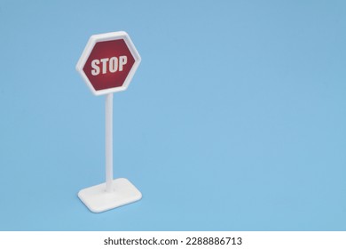 Stop sign on blue background. Copy space for text. - Shutterstock ID 2288886713