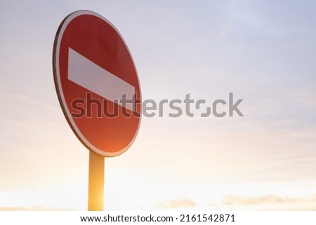 Stop sign on blue sky. It is not permitted to drive there.