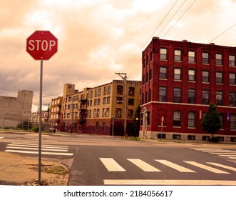 Stop Sign On City Street Intersection With Industrial Buildings