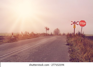 Stop Sign On A Rural Road On Rail Crossing