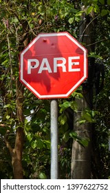 Stop sign placed at street corners where cars should stop. PARE = STOP Translation - Shutterstock ID 1397622752