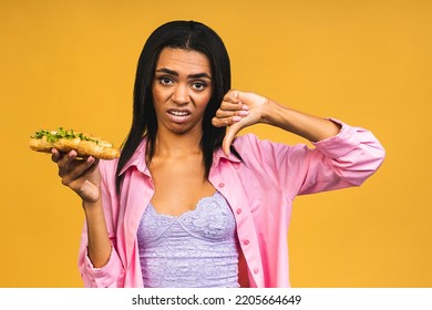 Stop Sign. Portrait Of Her She Nice Attractive Lovely Sad African American Girl Holding In Hand Tasty Burger Having Gastritis Isolated On Yellow Background.