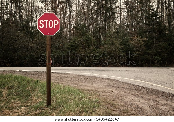 Stop sign at rural road\
intersection.