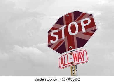 Stop Sign And Uk Flag On Gray Background. Pandemic And Coronavirus Concept. Travel Ban In The UK