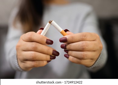 Stop Smoking Cigarettes Concept. Portrait Of Girl Holding Broken Cigarette In Hands. Quit Bad Habit, Health Care Concept. No Smoking.