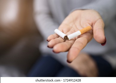 Stop Smoking Cigarettes Concept. Portrait Of Girl Holding Broken Cigarette In Hands. Quit Bad Habit, Health Care Concept. No Smoking.