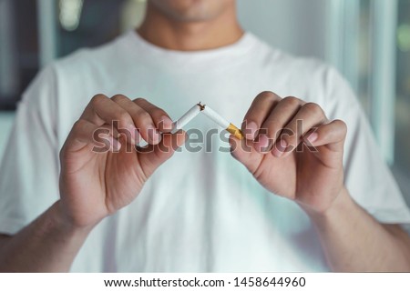 Stop smoking cigarettes concept. Portrait of beautiful  holding broken cigarette in hands. Happy , health care concept. No smoking.