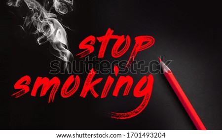 Stop smoking words, red pencil and smoke on black background. No smoking quit addiction concept.