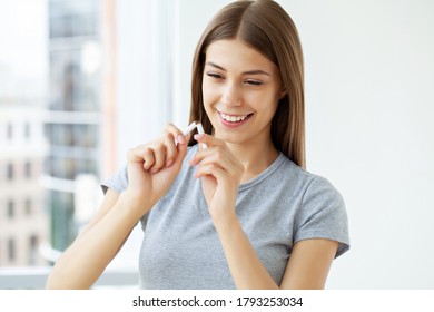 Stop smoking, a young woman holding a broken cigarette