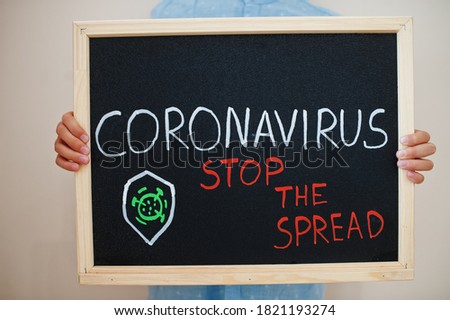 Stop the spread. Coronavirus concept. Boy hold inscription on the board.