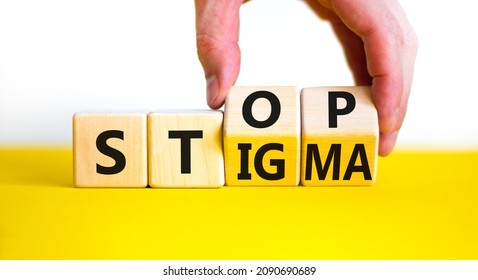 Stop stigma symbol. Doctor turns wooden cubes with words stop stigma. Beautiful yellow table, white background. Medical and stop stigma concept. Copy space.