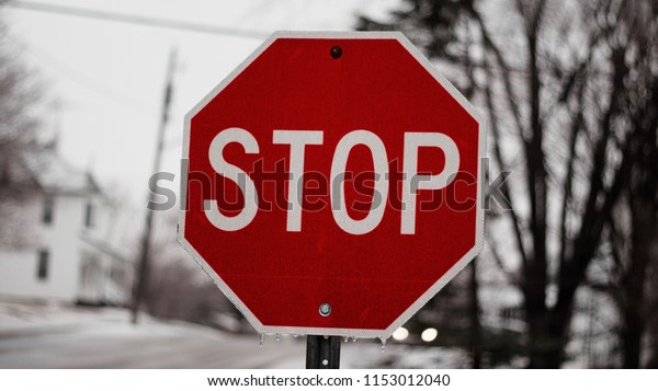 Stop street sign in winter break hazard drive\
carefully in the weather\
season