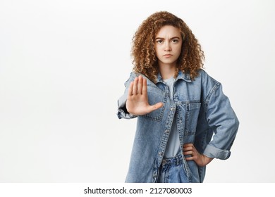 Stop, Taboo Concept. Young Serious Woman Showing No, Prohibit, Rejection Gesture, Forbid Smth Bad, Standing Over White Background