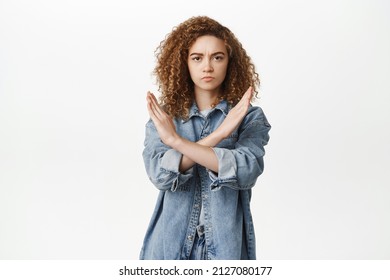 Stop, Taboo Concept. Young Serious Woman Showing No, Prohibit, Rejection Gesture, Forbid Smth Bad, Standing Over White Background