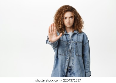 Stop, Taboo Concept. Young Serious Woman Showing No, Prohibit, Rejection Gesture, Forbid Smth Bad, Standing Over White Background