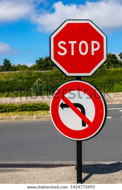 Stop traffic\
sign no left turn. Traffic restriction Against the background of\
the road and the bright\
sky
