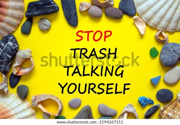 Stop trash talking yourself symbol. Concept words\
Stop trash talking yourself on a beautiful yellow background. Sea\
stones and seashells. Psychological stop trash talking yourself\
concept. Copy space.