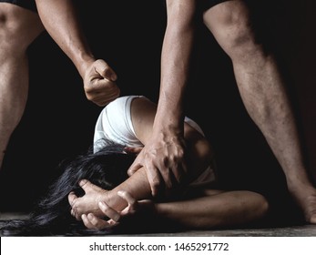 stop violence against women, Girl trying to escape from domestic violence, sexual abuse with a man attacking to a scared woman in a dark place, 