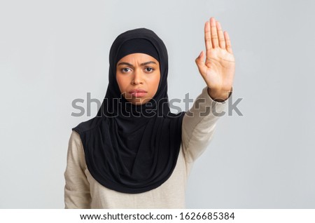 Stop Violence Concept. Serious Black Muslim Woman In Hijab Showing No With Her Hand, Tired Of Discrimination, Light Studio Background, Free Space