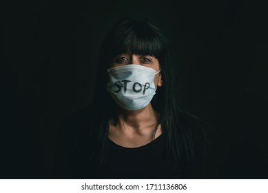 Stop Violence,scared Woman Wearing Medical Mask For Coronavirus Victim Of Domestic Violence Over Black Background