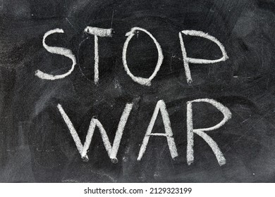 Stop war, handwritten with a chalk on the blackboard - Shutterstock ID 2129323199