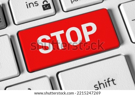 Stop word on the button of the white computer keyboard. The concept of stopping work, playing, war, procrastination, ending podcast, streaming
